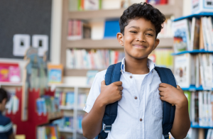 Young smiling school student with backpack on.